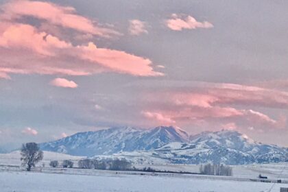 Pink sunset over snow covered mountains